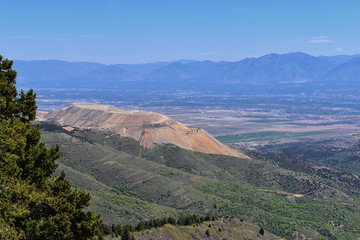 Panoramic view of Wasatch Front Rocky Mountains from the Oquirrh Mountains, by Kennecott Rio Tinto Copper mine, Utah Lake and Great Salt Lake Valley in early spring with melting snow and Cloudscape. U