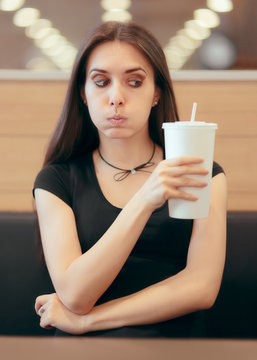 Woman with Soda Disposable Cup Waiting in Fast Food Diner