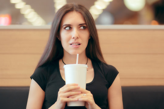Woman with Soda Disposable Cup Waiting in Fast Food Diner