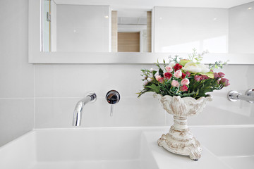 Close-up luxury wash basin, mirror and flower  in  bathroom, On white wall room