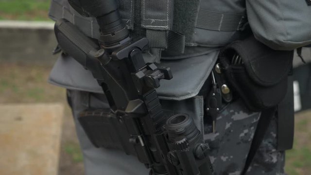 Detail of assault rifle weapon held by a SWAT team officer.