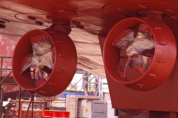 Marine propellers on a vessel during dry dock repairs.