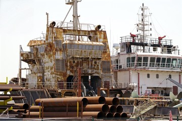 Rusted boat waiting to depart for scraping.