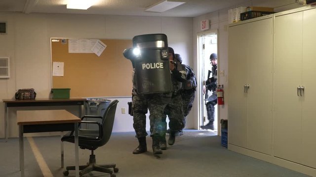 A SWAT police team moves to make a combat assault in counterterrorism training.