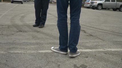 A drunk person tries to pass a DUI test during a traffic stop with a police officer.