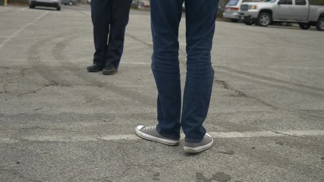A drunk person tries to pass a DUI test during a traffic stop with a police officer.