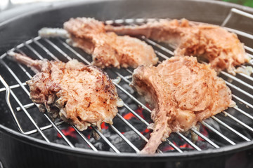 Cooking of appetizing juicy spare ribs outdoors
