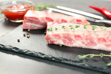 Slate plate with fresh raw ribs on table