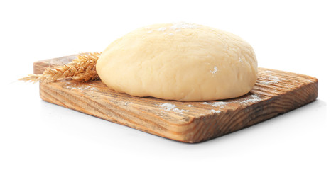 Wooden board with raw dough on white background