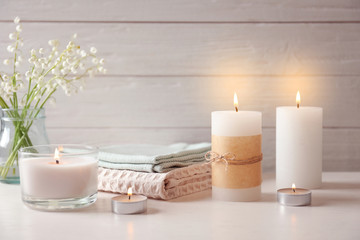 Beautiful composition with burning wax candles on table