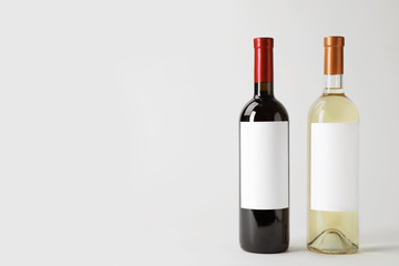 Bottles of delicious wines with blank labels on white background