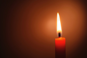 Wax candle burning in darkness, closeup