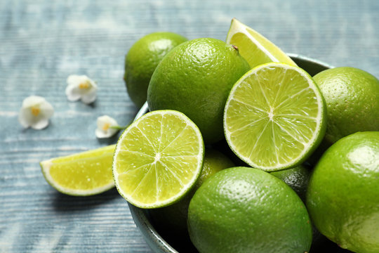 Bowl with fresh ripe limes on table, closeup