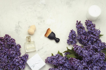 Accessories for make-up and skin care, perfumes, lilacs on a lig