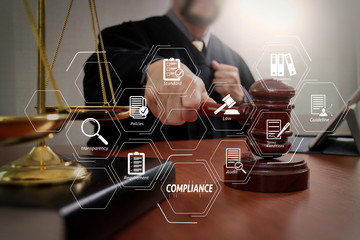 justice and law concept.Male judge in a courtroom with the gavel,working with smart phone and...