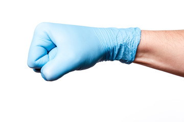 Doctor's hand in a blue surgical glove strikes
