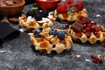 Belgian waffles with pomegranate and raspberries, homemade healthy breakfast with mint