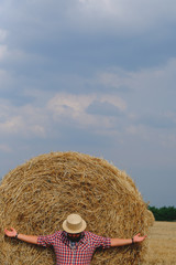 man resting after hay in haystacks