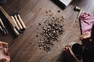 Cutting clay and tools on a wooden table