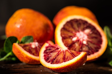 Whole and cut ripe juicy Sicilian Blood oranges