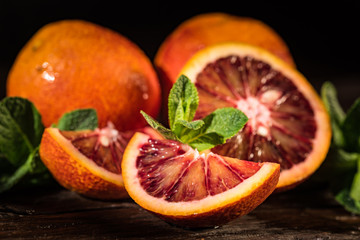 Whole and cut ripe juicy Sicilian Blood oranges