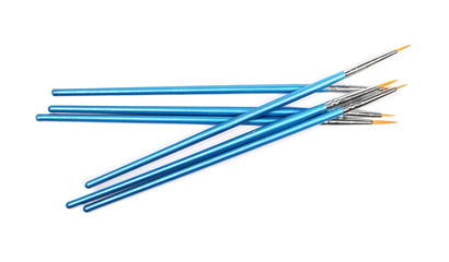 Blue paintbrushes isolated on white background, top view