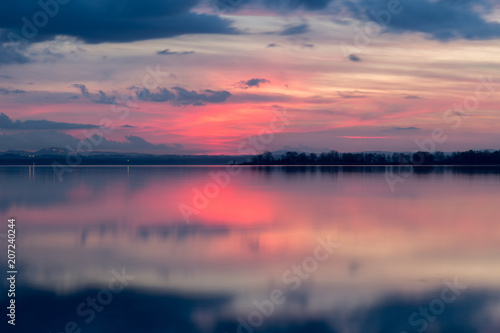 Perfectly Symmetric Reflection Of Sunset On A Lake With