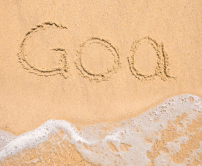 The word Goa written in the sand on beach
