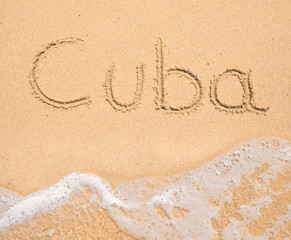 The word Cuba written in the sand on beach