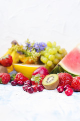 Exotic tropical fruits on white background, healthy food, vegetarian diet. Copy space.