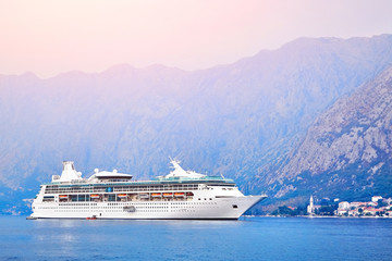 Cruise liner near the coast and mountains.
