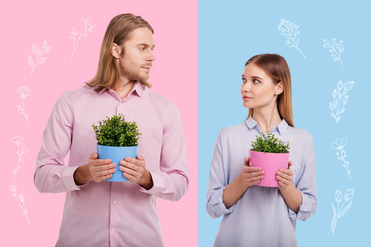 Common hobby. Calm couple wearing similar casual clothes and looking at each other while standing with flower pots
