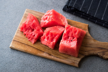 Seedless Watermelon Slices Ready to Eat on Wooden Surface.