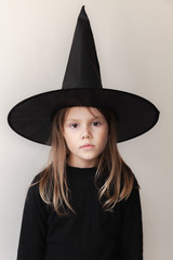 European girl in black witch costume