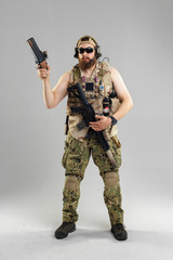 Special forces soldier with rifle on white background.