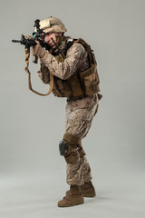 Soldier in camouflage holding rifle