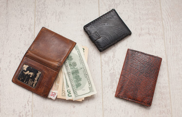 Money in wallets. Friends company. Mens wallet.