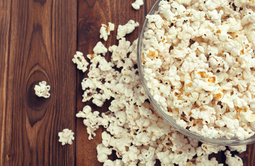Salt popcorn on the wooden table
