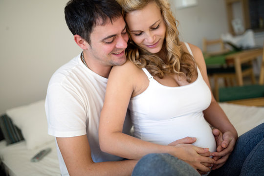 Happy pregnant woman relaxing with her husband