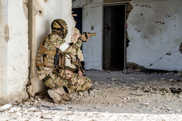 Soldier with hand gun inside building