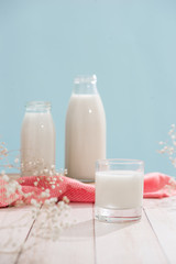 Dairy products. Bottle with milk and glass of milk on wooden table