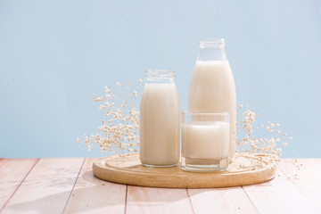 Dairy products. Bottle with milk and glass of milk on wooden table
