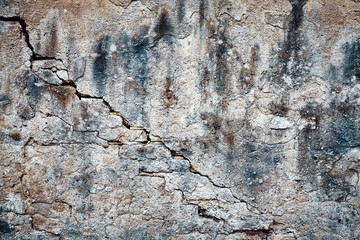 Vintage toned picture of an old grunge cracked wall, background or texture. 