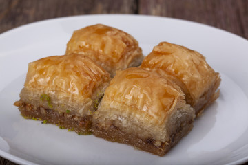 Baklava on table inside white plate