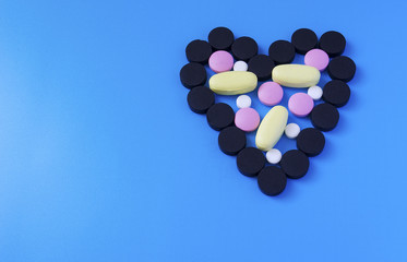 colored pills in a heart shape