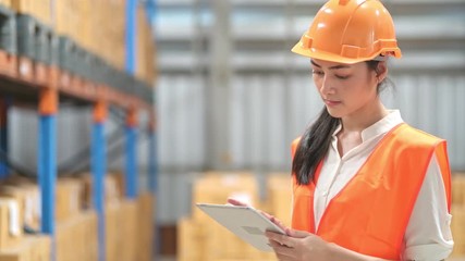 Woman in small warehouse checking stock, logistic concept. Young asian female inspector inspecting small warehouse. - Powered by Adobe