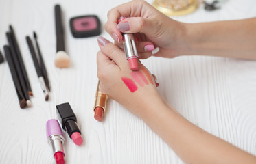 Fashion lips make-up collection. Hot visage background with red pomade. Makeup artist demonstrate...