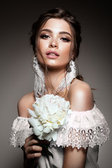 Glamour portrait of beautiful woman model with fresh daily makeup and romantic wavy hairstyle....
