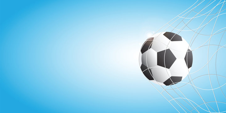 Soccer football in Goal net on blue background.