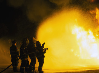 JOHANNESBURG, SOUTH AFRICA - MAY, 2018 Firefighters pointing towards fire during fighting training exercise